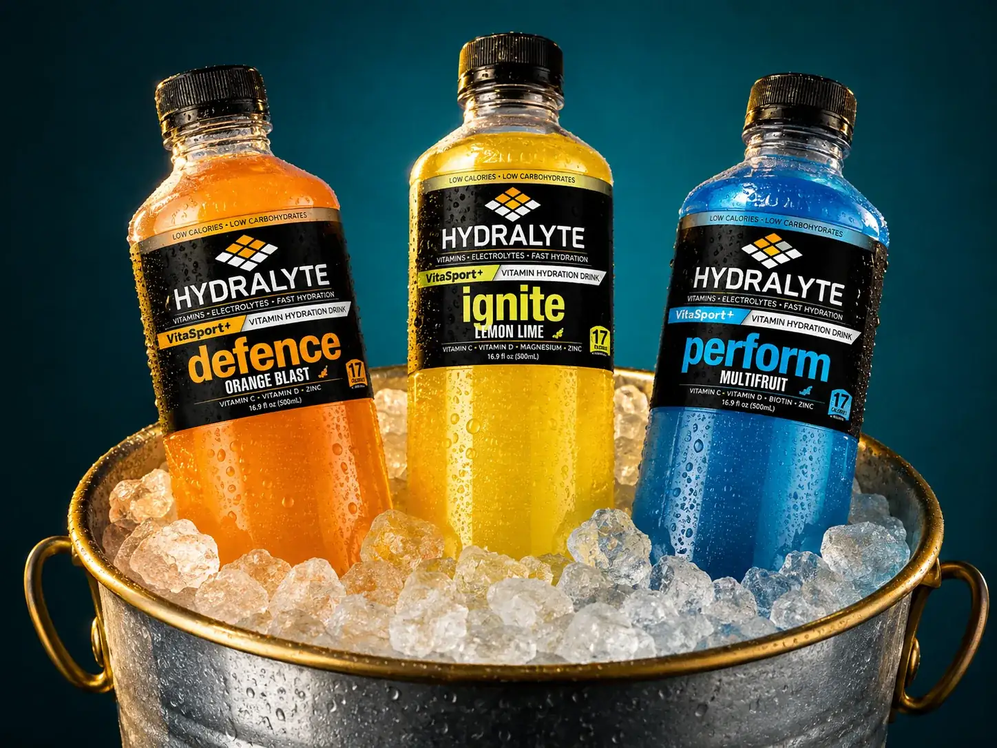 Three VitaSport+ 500 ml bottles standing in a galvanised ice bucket with crushed ice and condensation